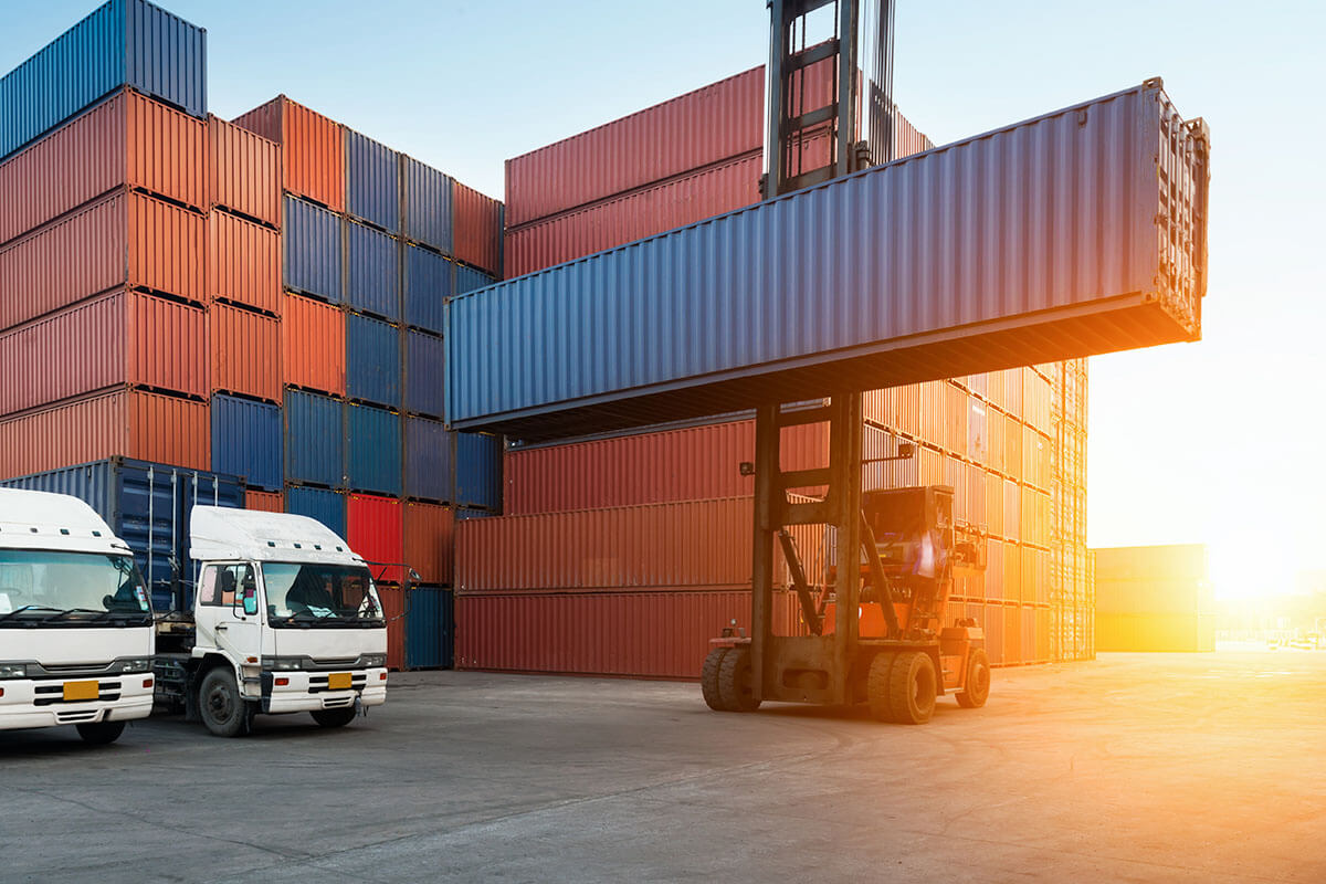 Forklift moving a container