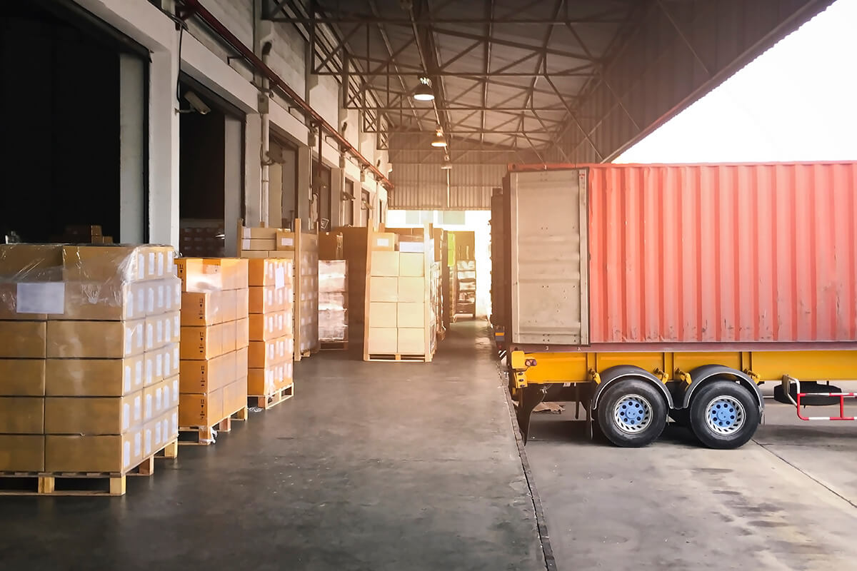 shipping container on truck being shipped to warehouse