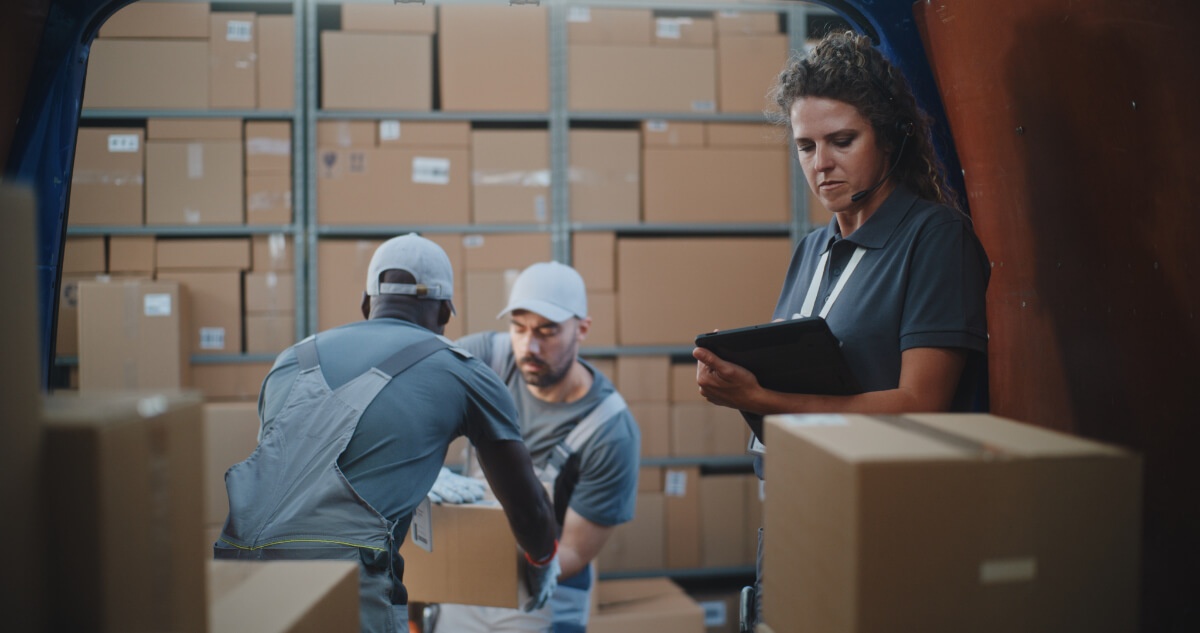 Multiethnic,Workers,Unloading,Cardboard,Boxes,With,Online,Orders,,E-commerce,Goods